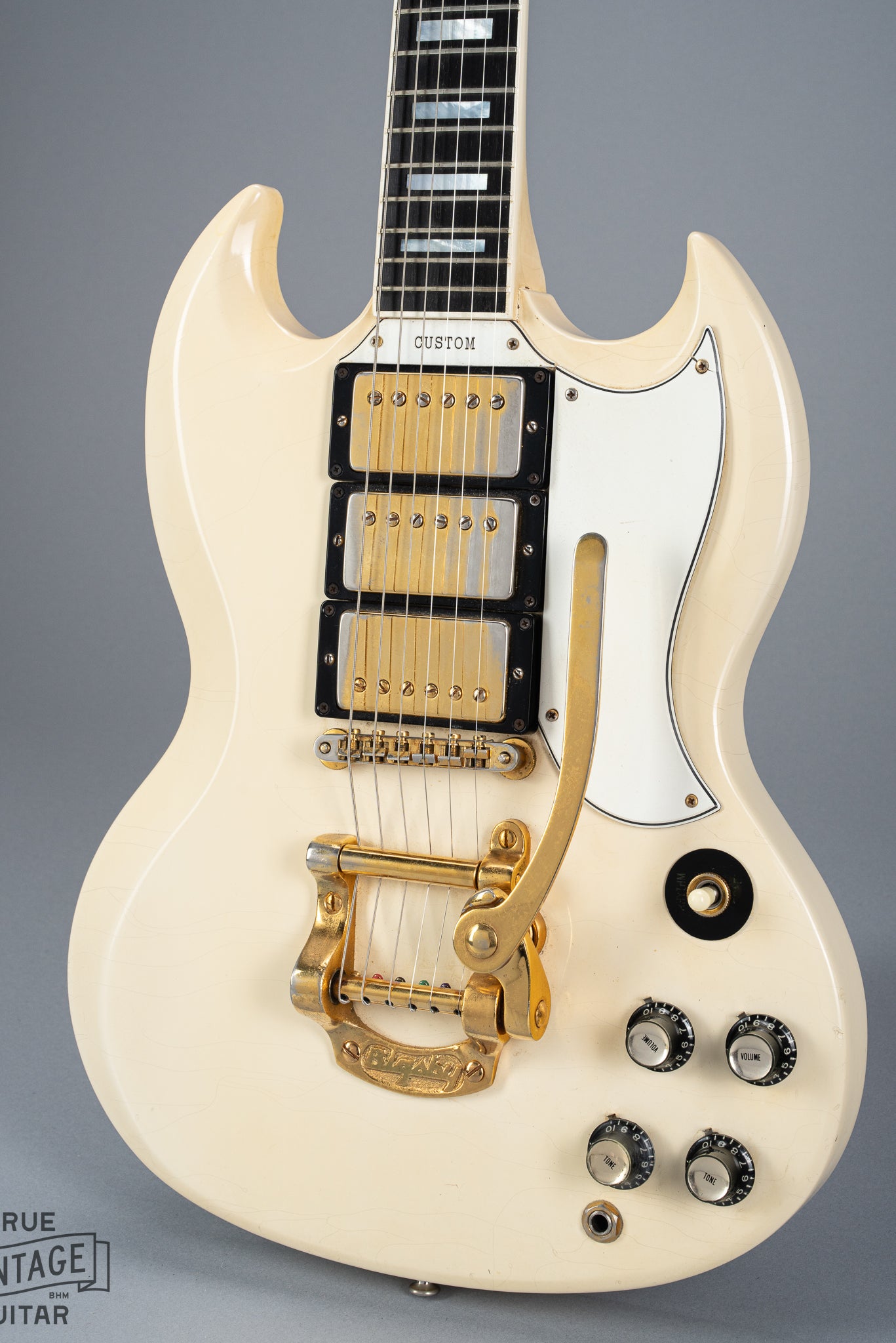 Front of 1965 Gibson SG Custom white guitar three pickup with Bigsby B5 vibrato tailpiece