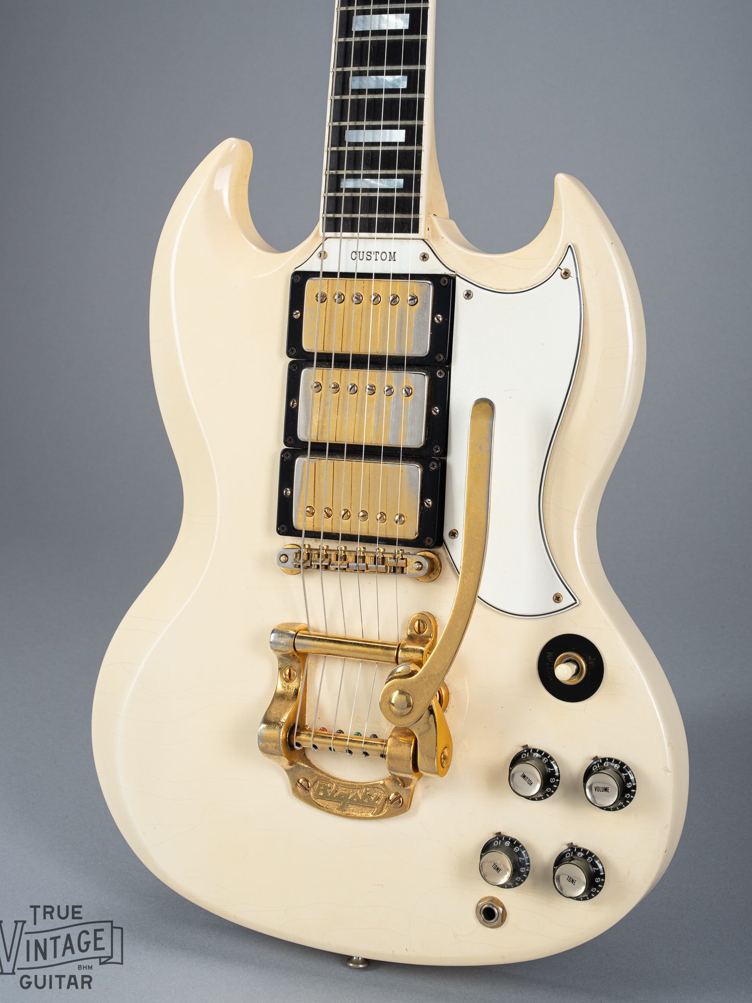 Front of 1965 Gibson SG Custom white guitar three pickup with Bigsby B5 vibrato tailpiece