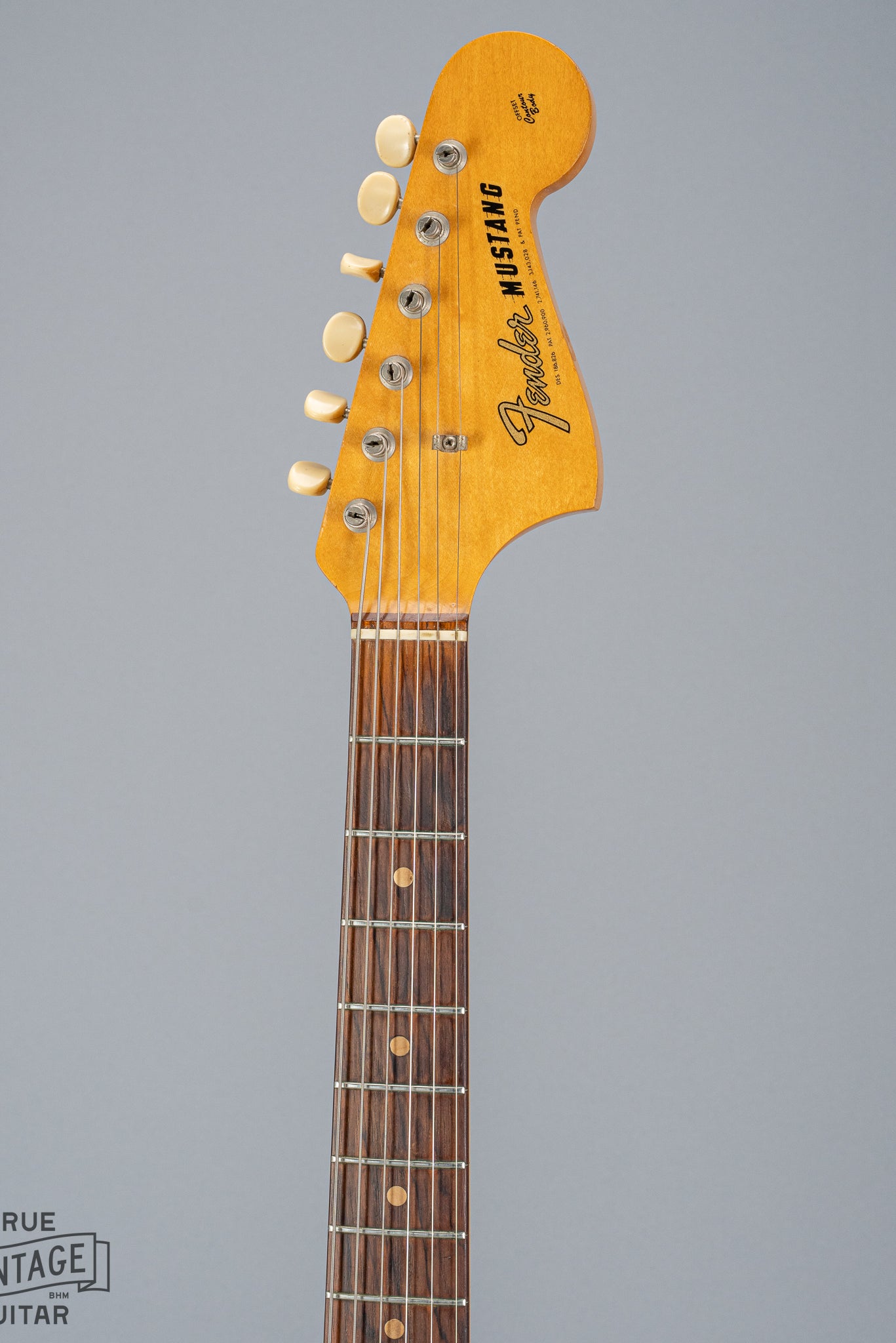 front of 1965 Fender Mustang Red guitar neck and headstock fretboard frets inlays tuning buttons
