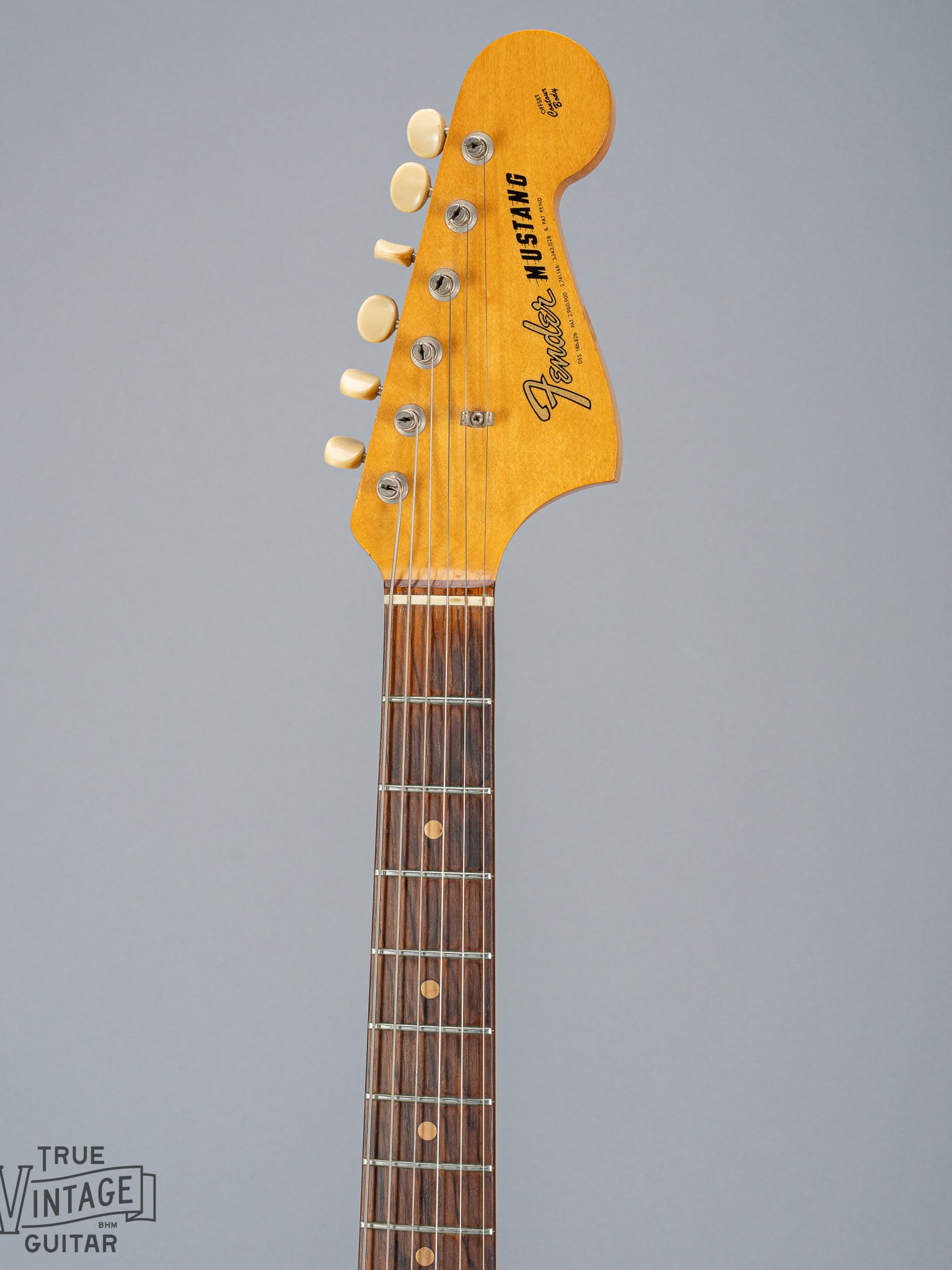 front of 1965 Fender Mustang Red guitar neck and headstock fretboard frets inlays tuning buttons
