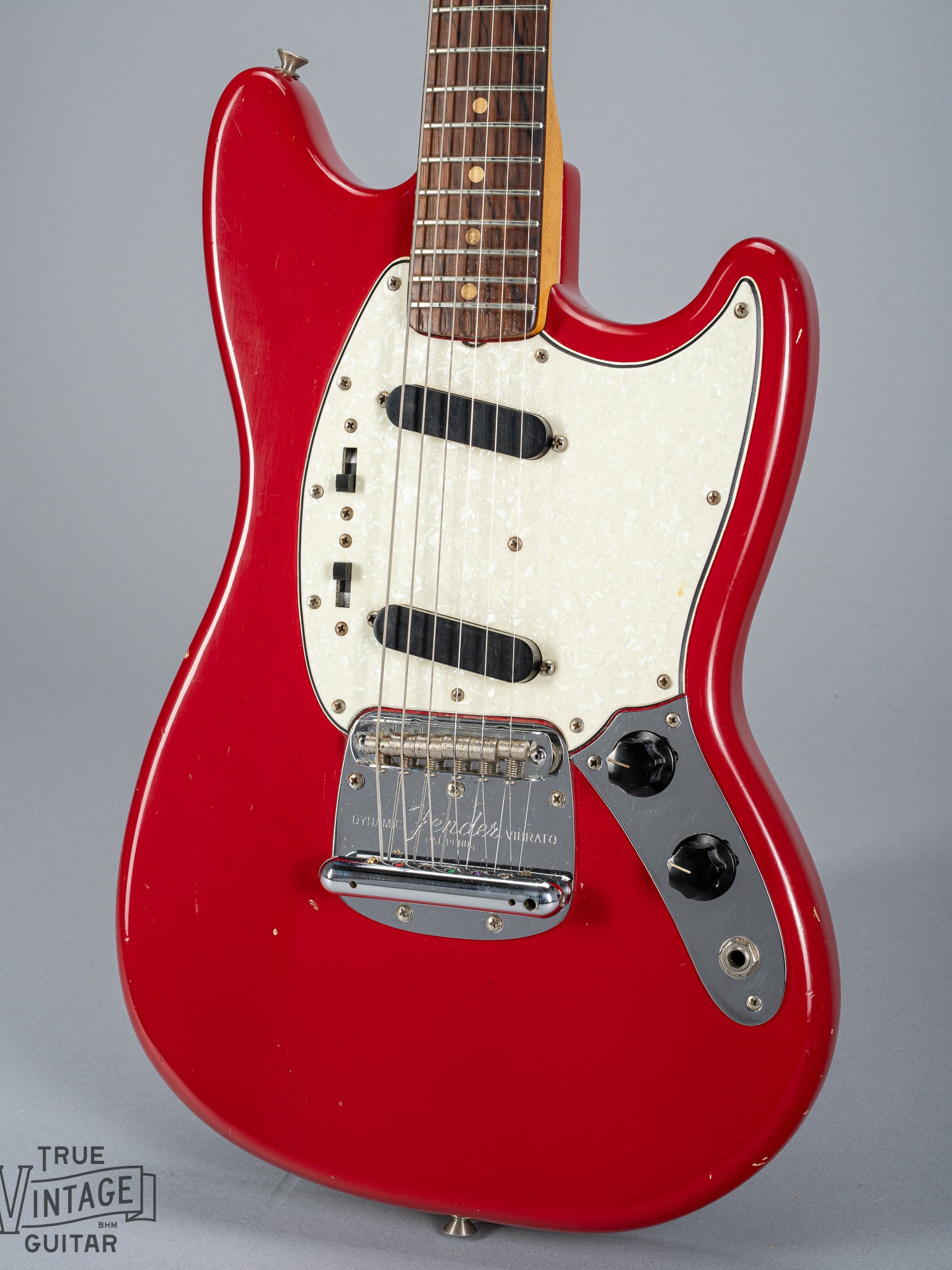 front of 1965 Fender Mustang Red guitar body sparkle pick guard single coils original hardware