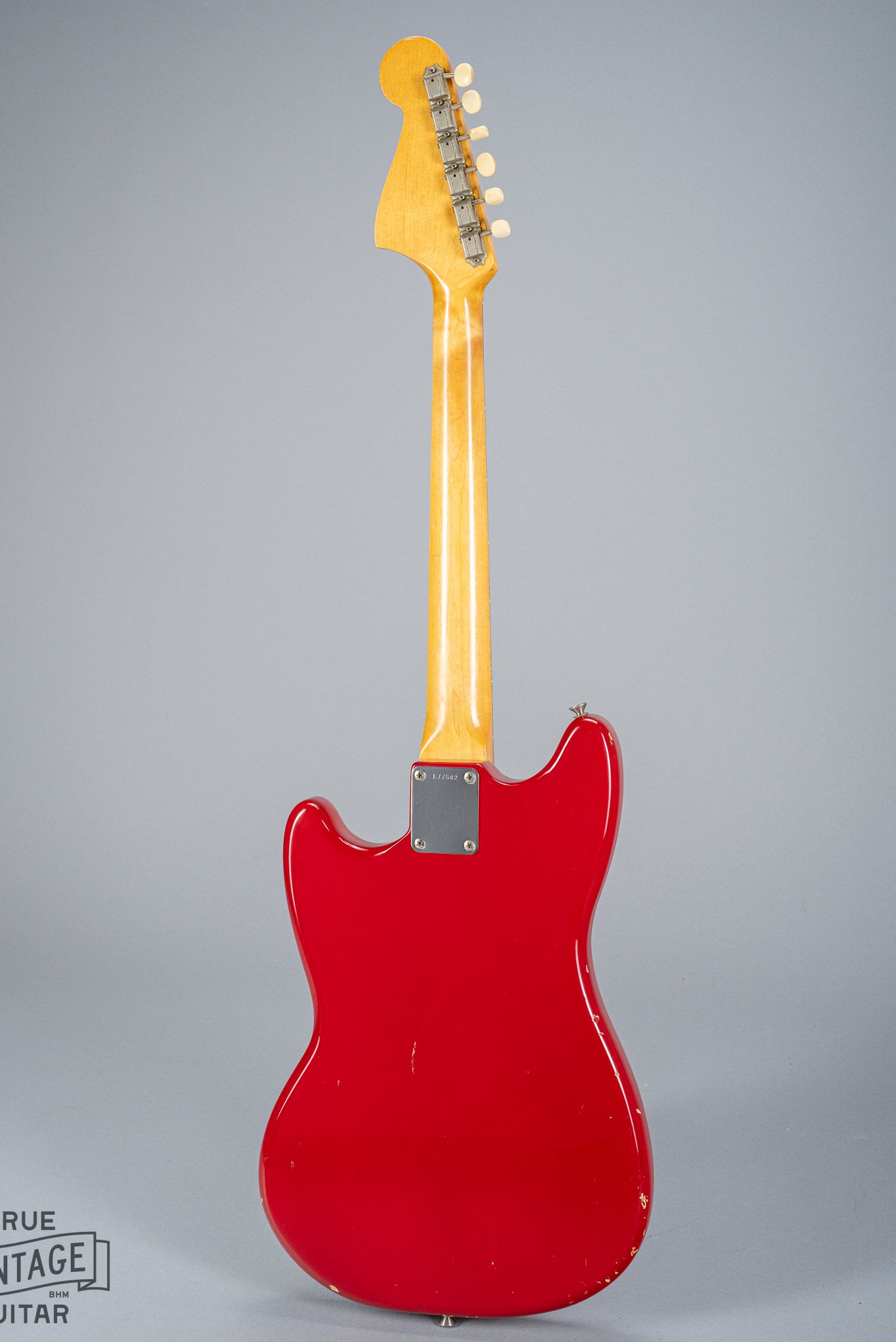 Back of 1965 Fender Mustang Red guitar neck plate serial number neck headstock tuning machines