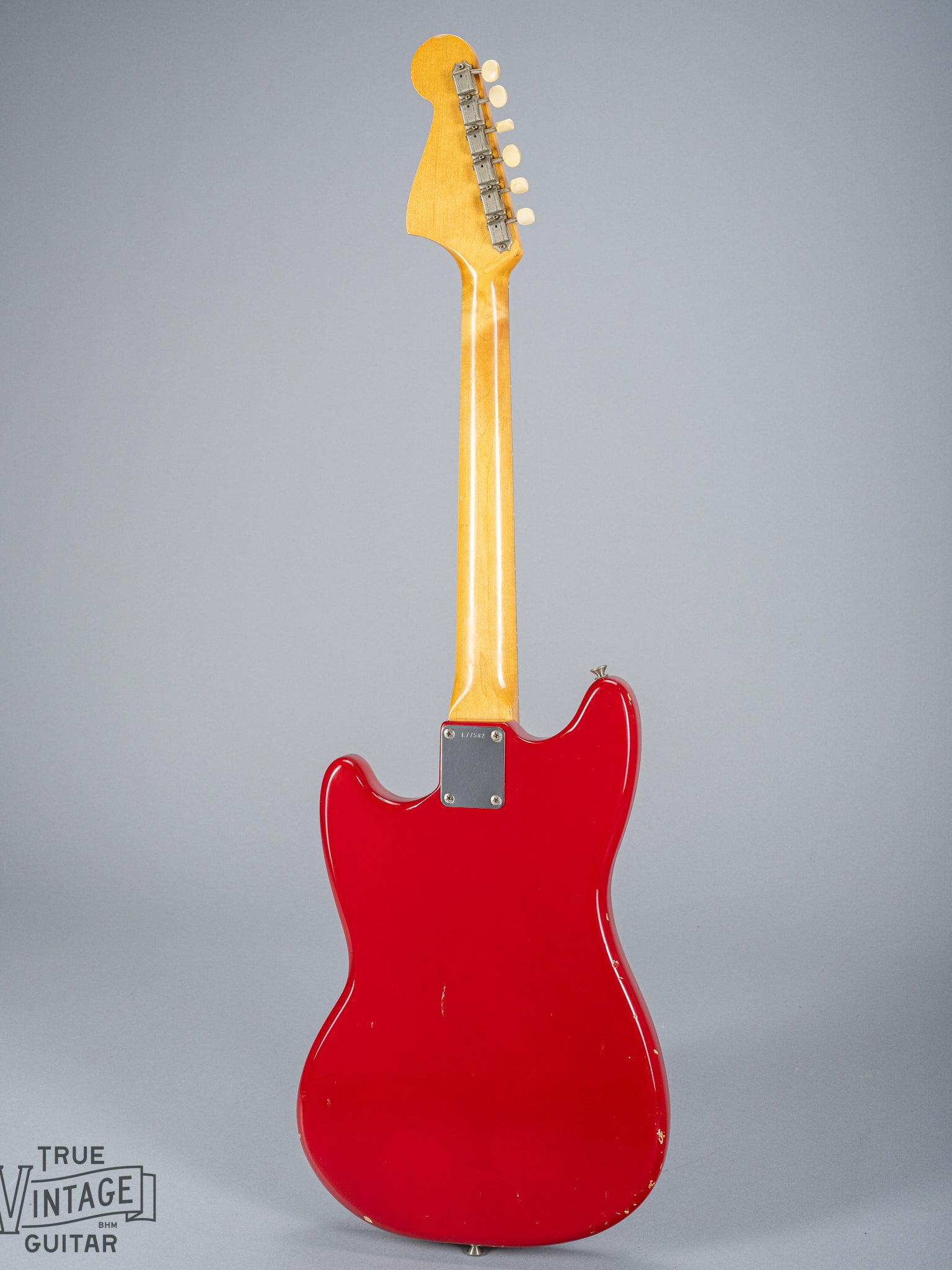 Back of 1965 Fender Mustang Red guitar neck plate serial number neck headstock tuning machines