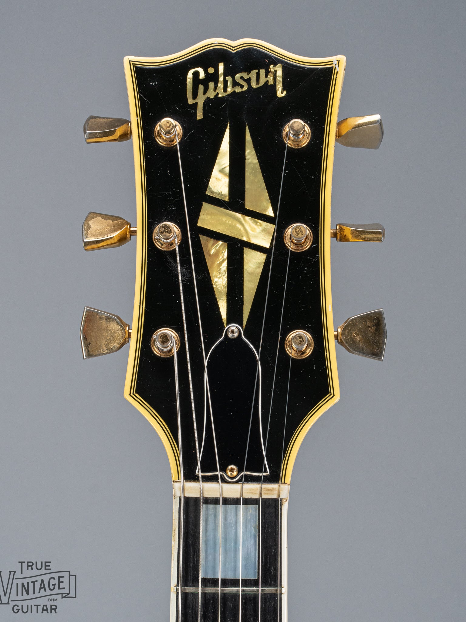 Front of 1965 Gibson SG Custom white guitar three pickup with Bigsby B5 vibrato tailpiece headstock