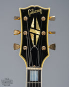 Front of 1965 Gibson SG Custom white guitar three pickup with Bigsby B5 vibrato tailpiece headstock