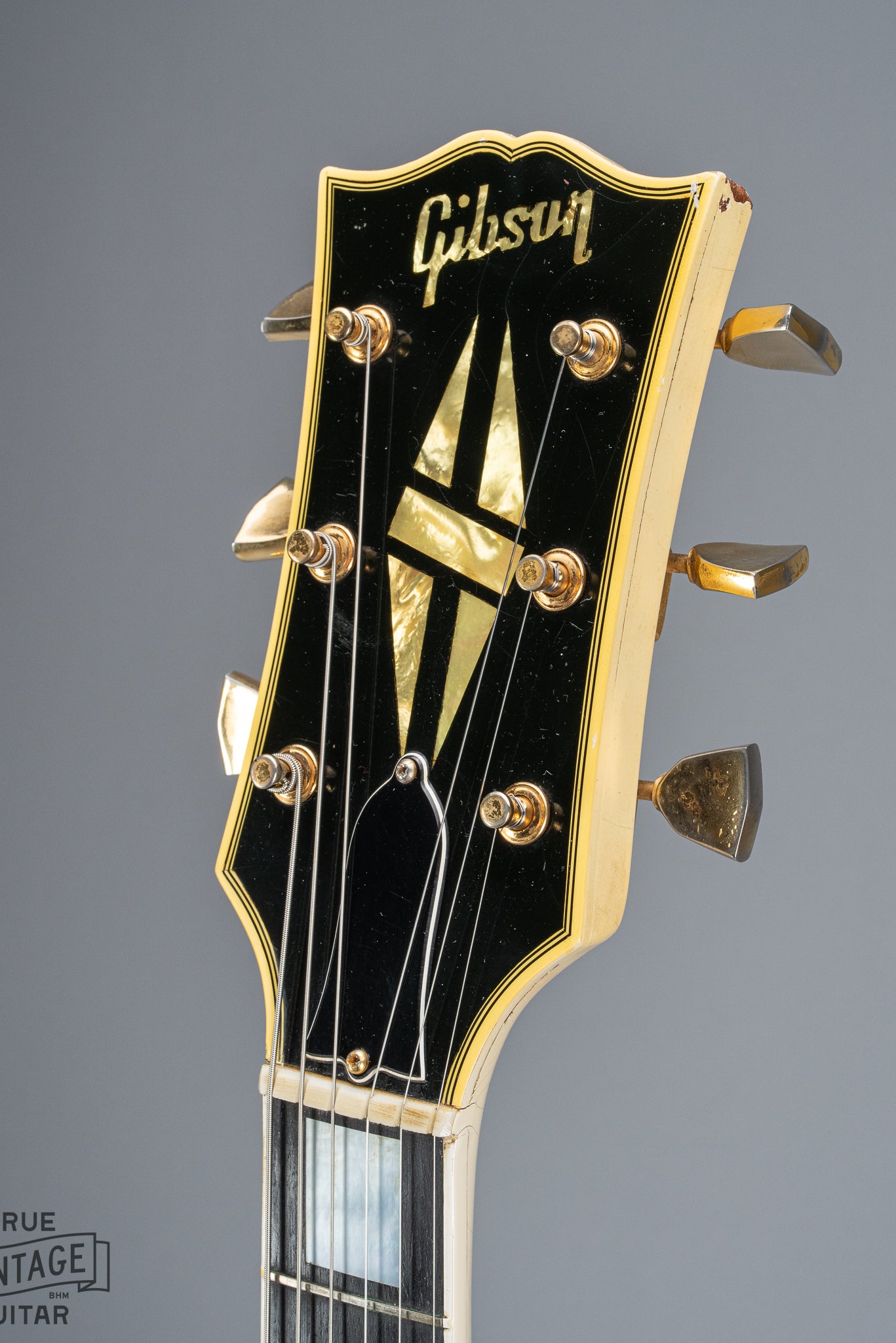 Front of 1965 Gibson SG Custom white guitar three pickup with Bigsby B5 vibrato tailpiece headstock