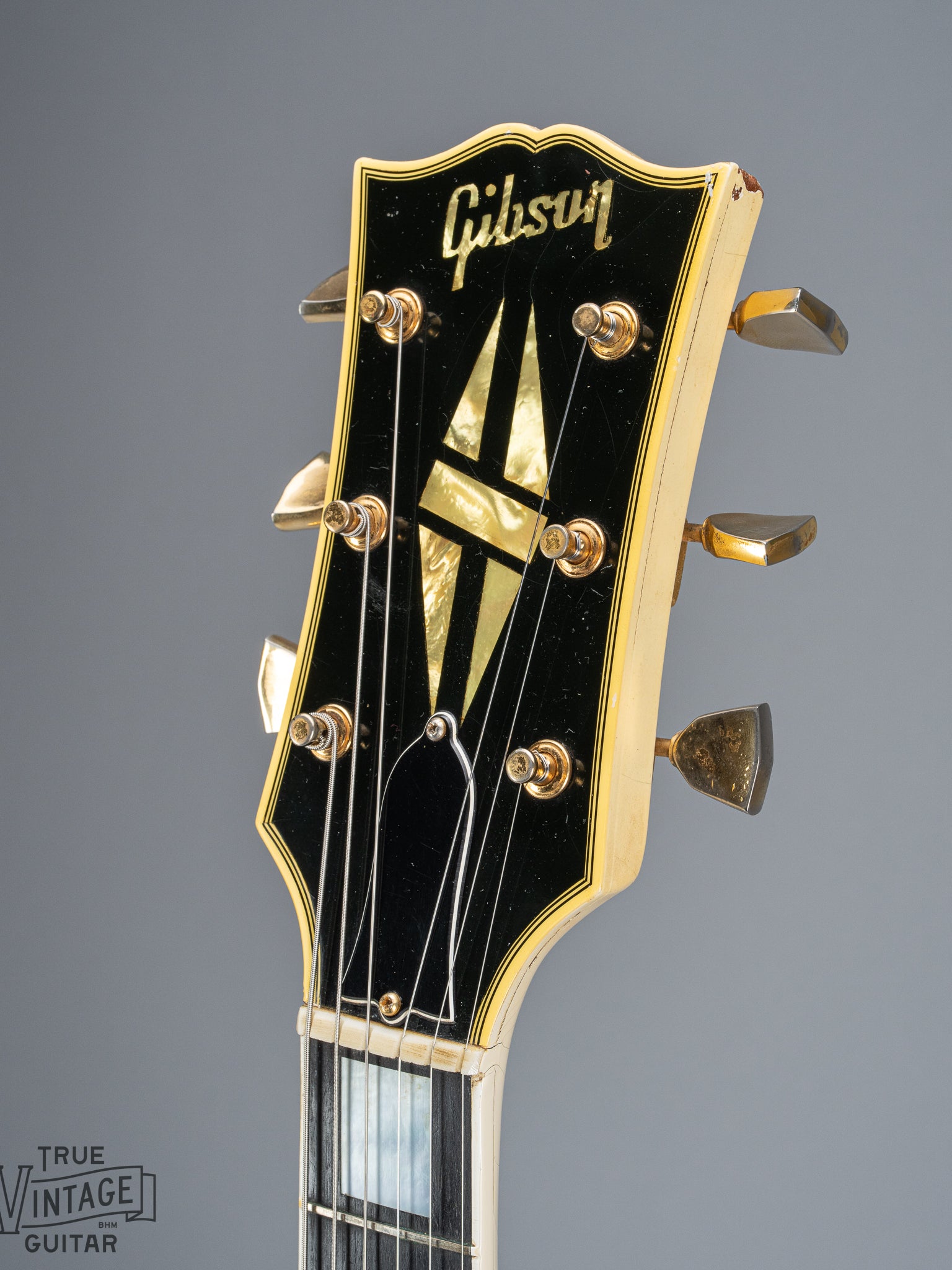 Front of 1965 Gibson SG Custom white guitar three pickup with Bigsby B5 vibrato tailpiece headstock