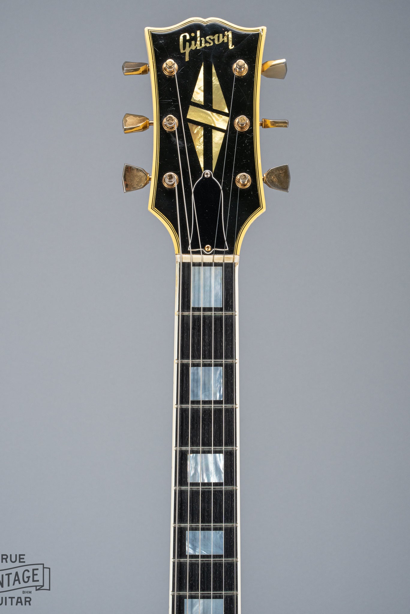 Front of 1965 Gibson SG Custom white guitar three pickup with Bigsby B5 vibrato tailpiece neck and headstock logo