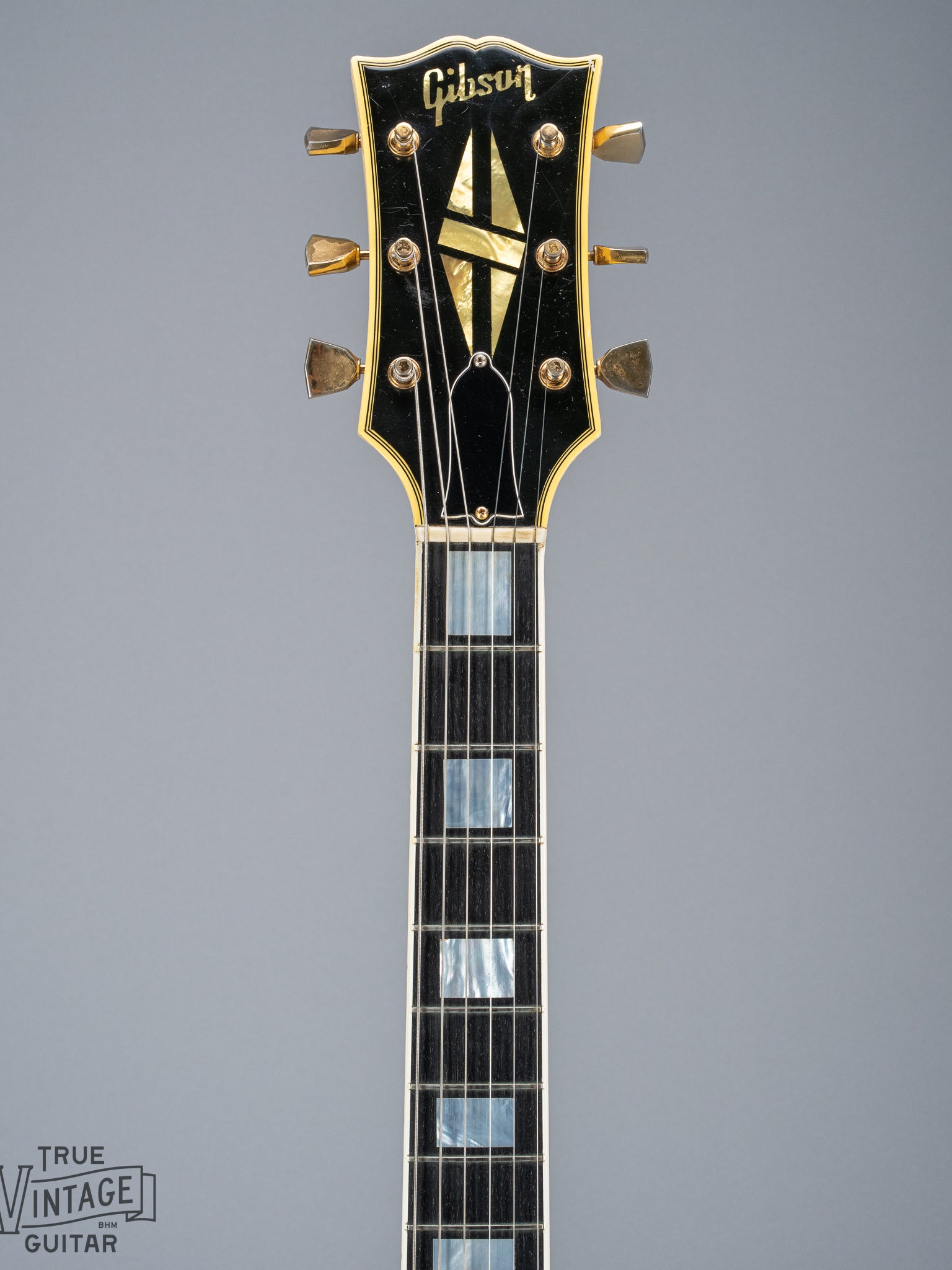 Front of 1965 Gibson SG Custom white guitar three pickup with Bigsby B5 vibrato tailpiece neck and headstock logo