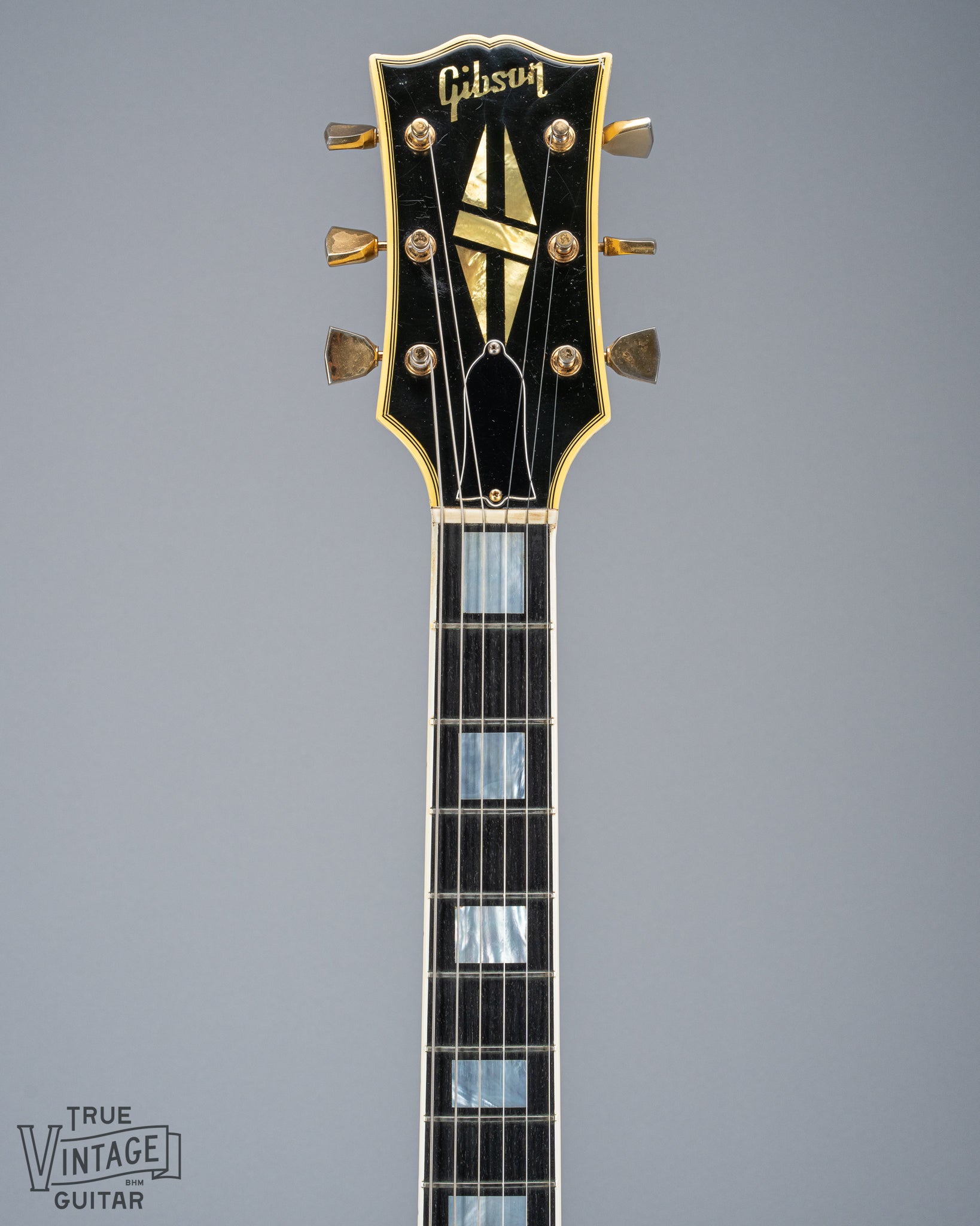 Front of 1965 Gibson SG Custom white guitar three pickup with Bigsby B5 vibrato tailpiece neck and headstock logo