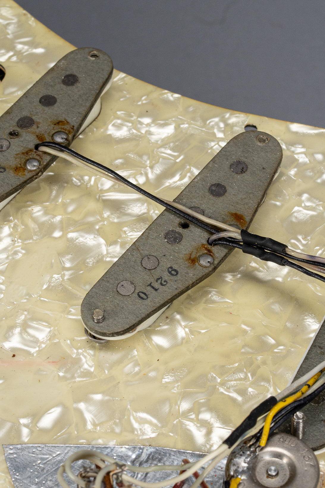 1970 Fender Stratocaster sunburst over white guitar interior pickups