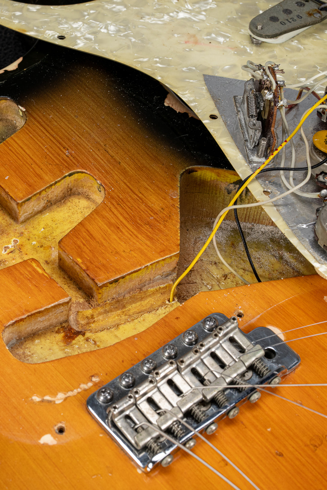 1970 Fender Stratocaster sunburst over white guitar interior cavities, wiring, electronics