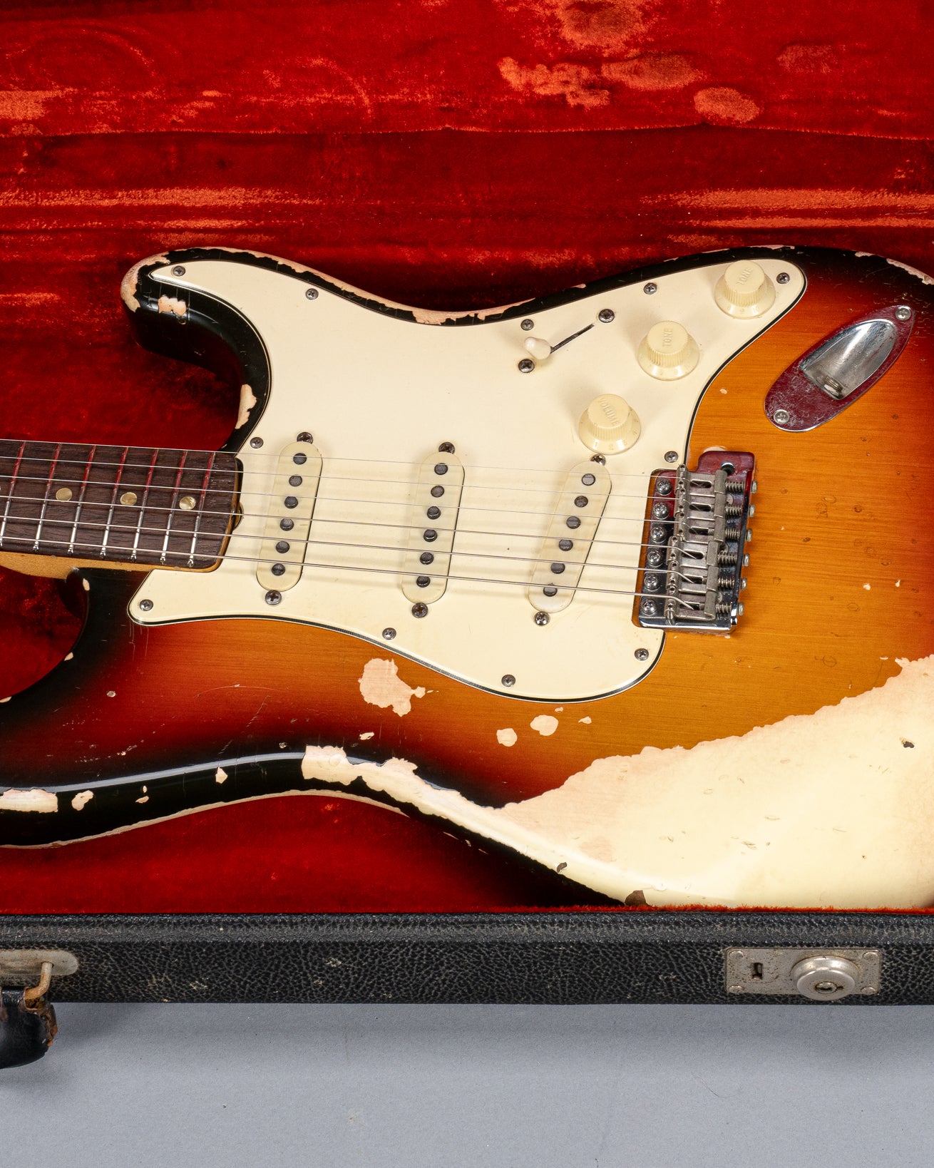front of 1970 Fender Stratocaster sunburst   over white guitar body in original case