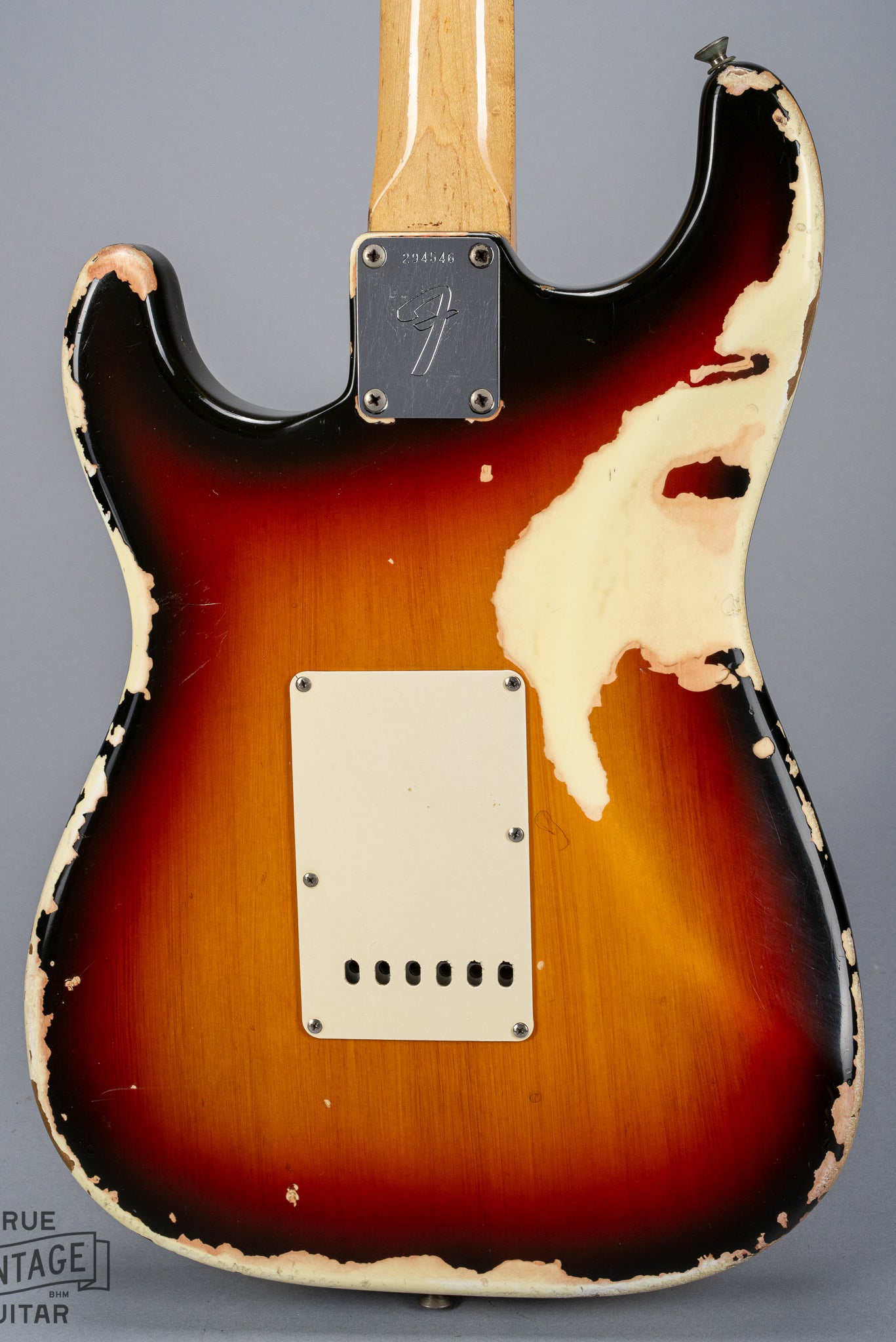 back of 1970 Fender Stratocaster sunburst over white finish distress F plate