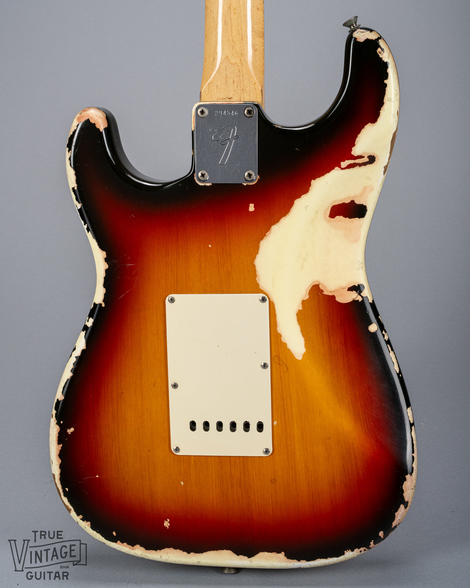 back of 1970 Fender Stratocaster sunburst over white finish distress F plate