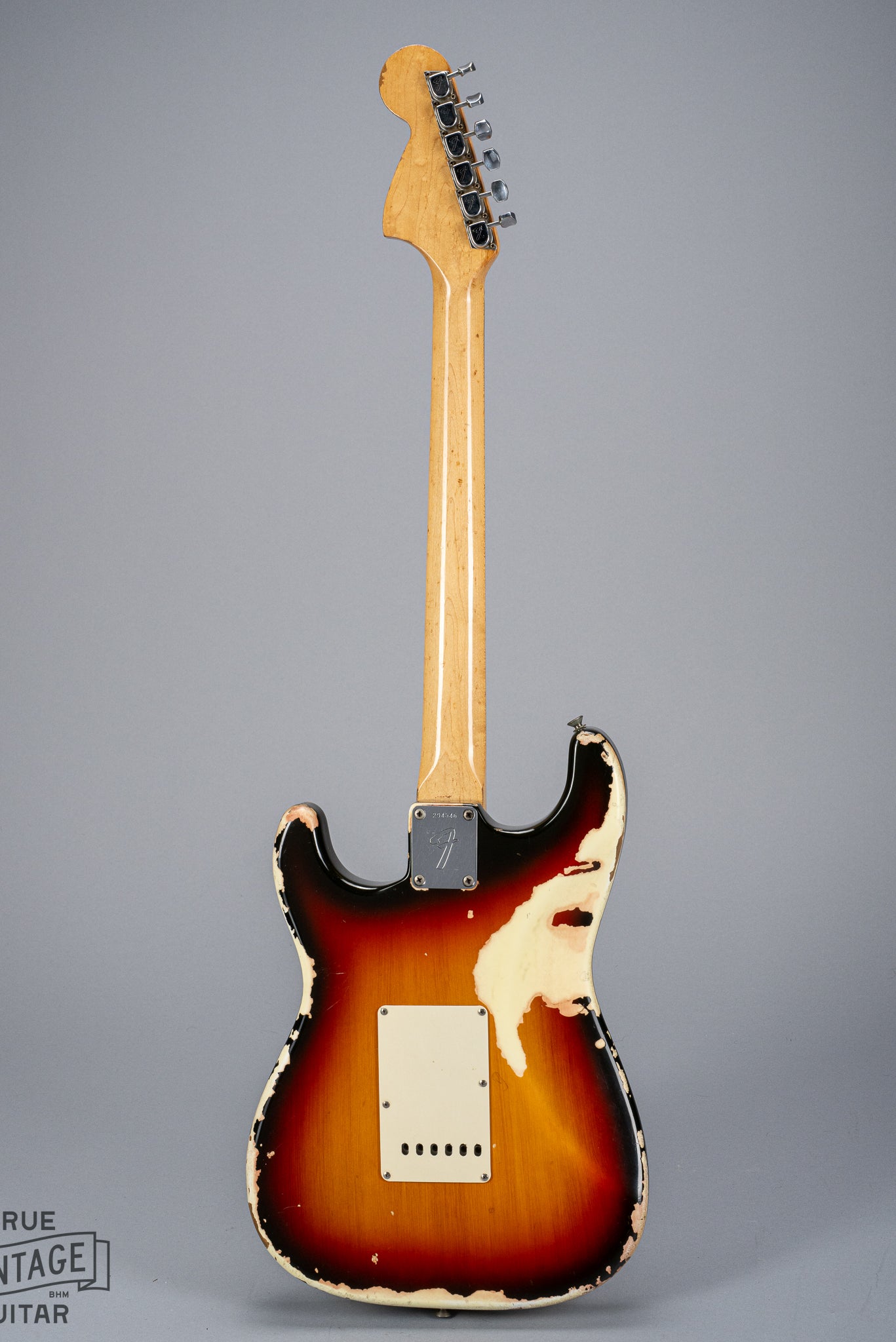 back of 1969 Fender Stratocaster sunburst over white finish distress F plate