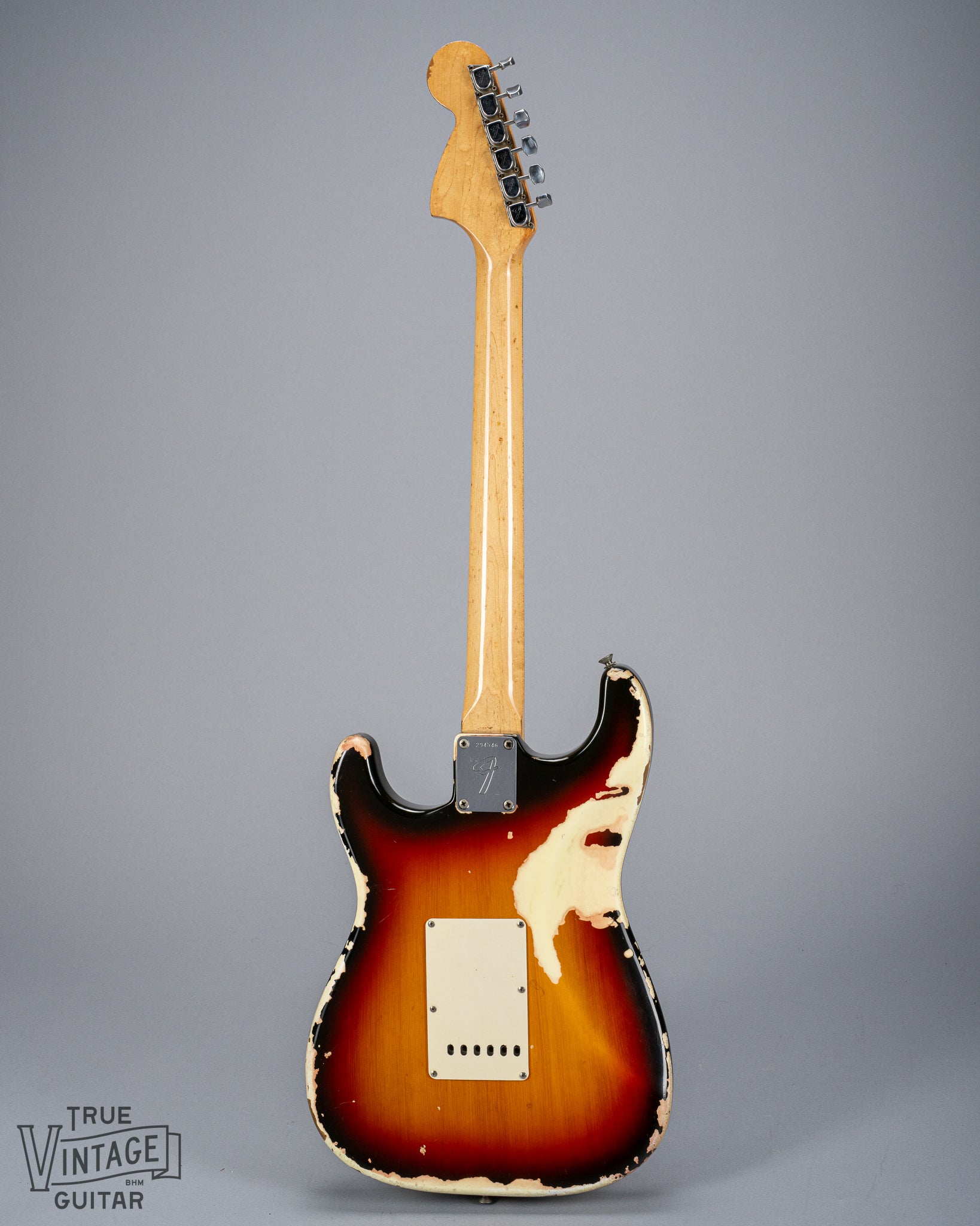 back of 1969 Fender Stratocaster sunburst over white finish distress F plate