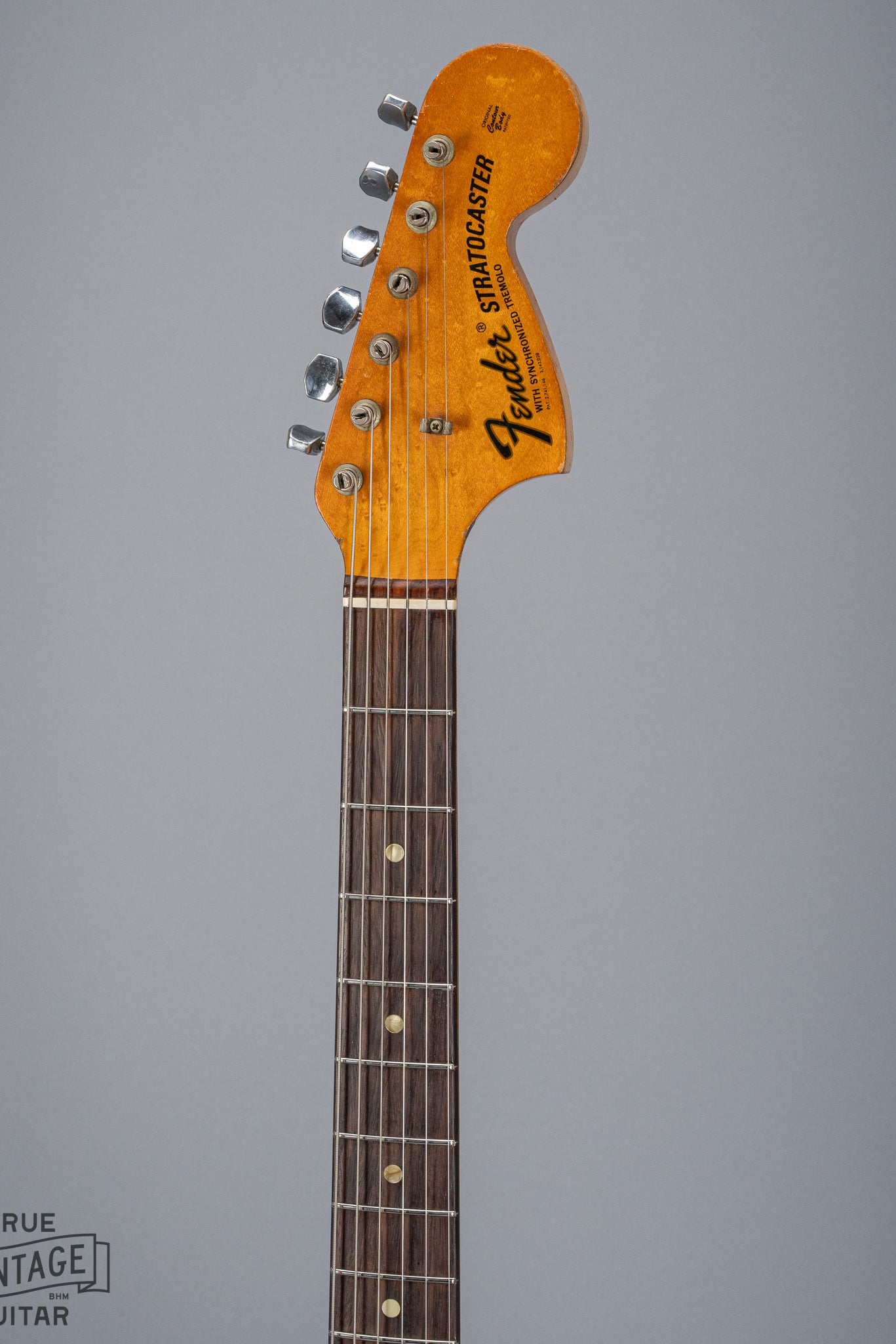 front of 1970 Fender Stratocaster sunburst over white headstock Fender logo tuners and original nut fretboard pearloid inlays