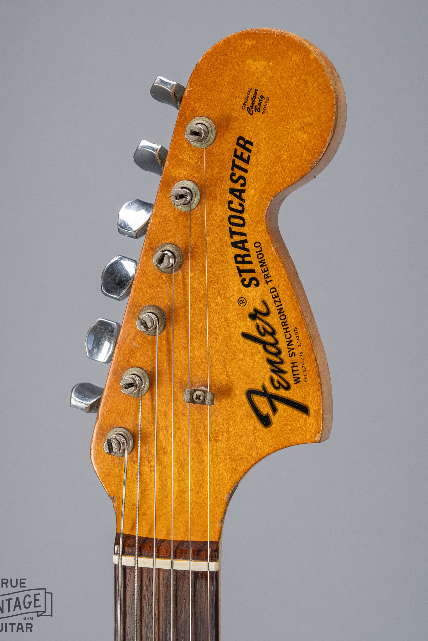 front of 1970 Fender Stratocaster sunburst over white headstock Fender logo tuners and original nut