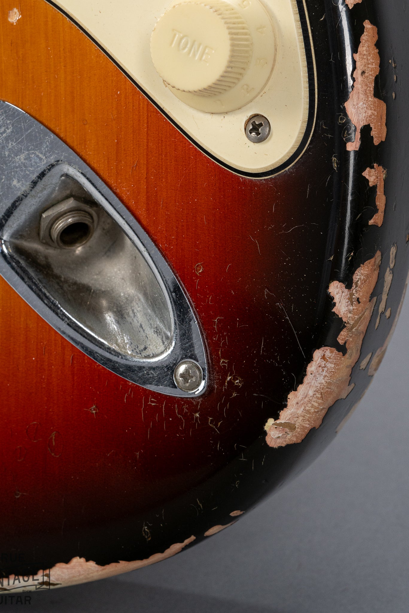 front of 1970 Fender Stratocaster sunburst over white finish distress