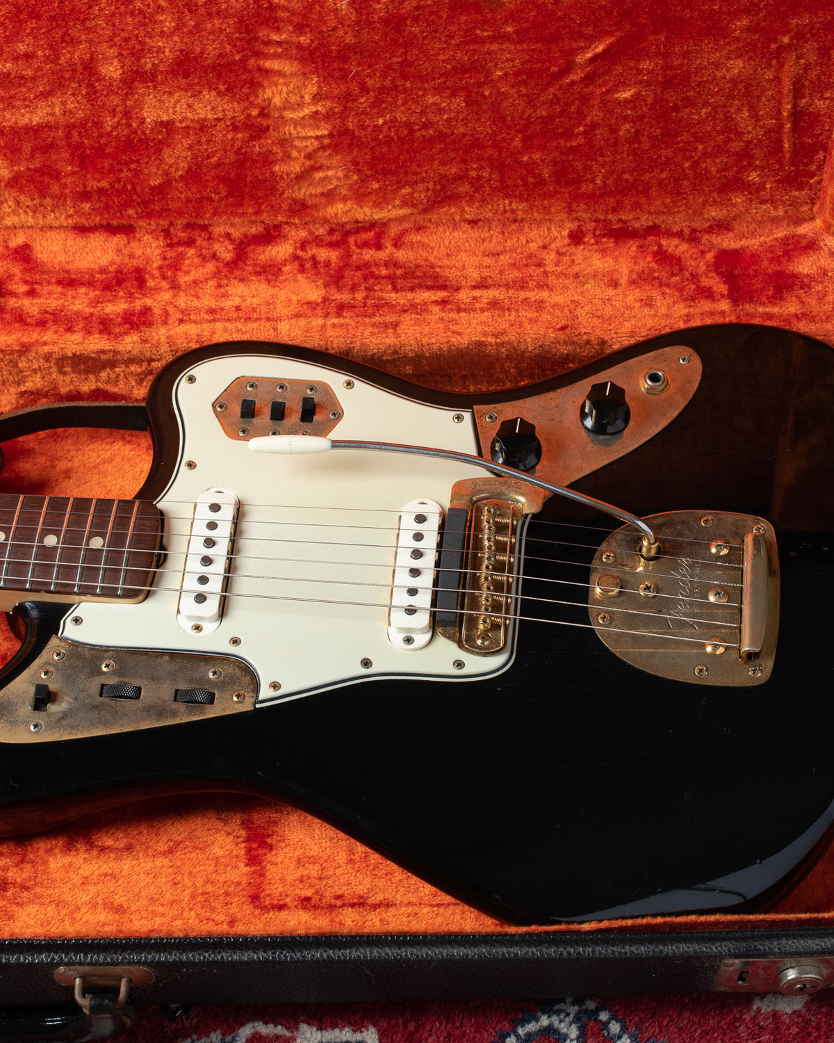 Black Jaguar with gold hardware. Vintage Fender guitar from 1965.