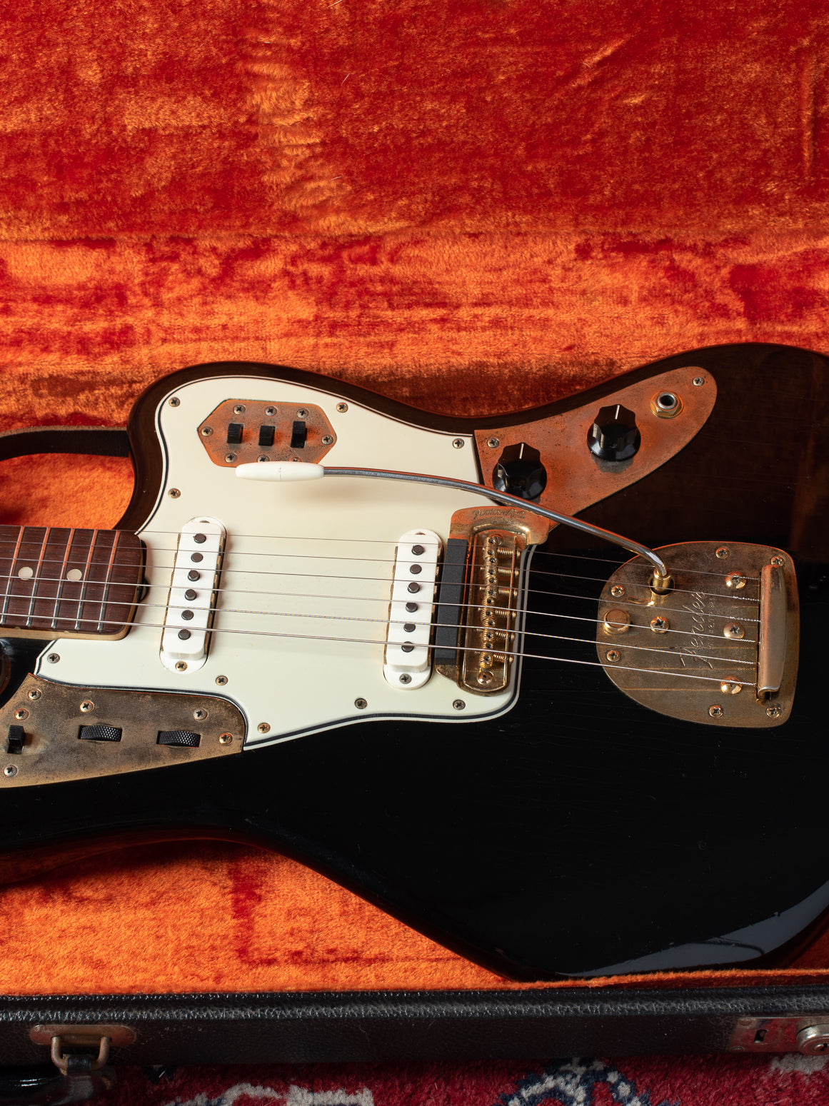 Black Jaguar with gold hardware. Vintage Fender guitar from 1965.