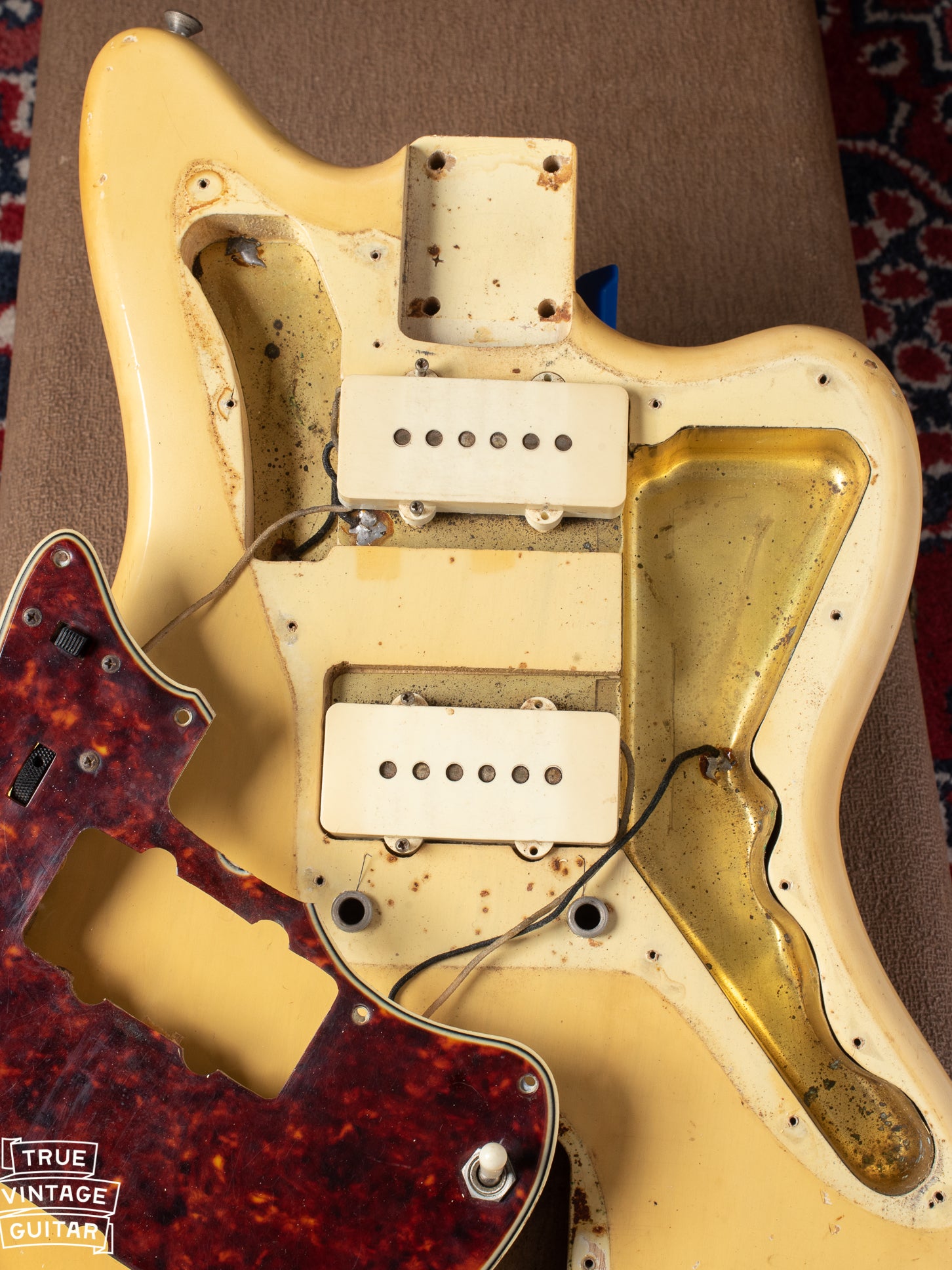 Body under pickguard showing clear nail holes