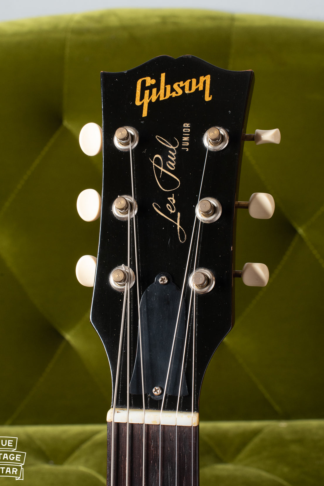 Black Headstock showing gold Gibson logo and Les Paul signature with Junior model underneath