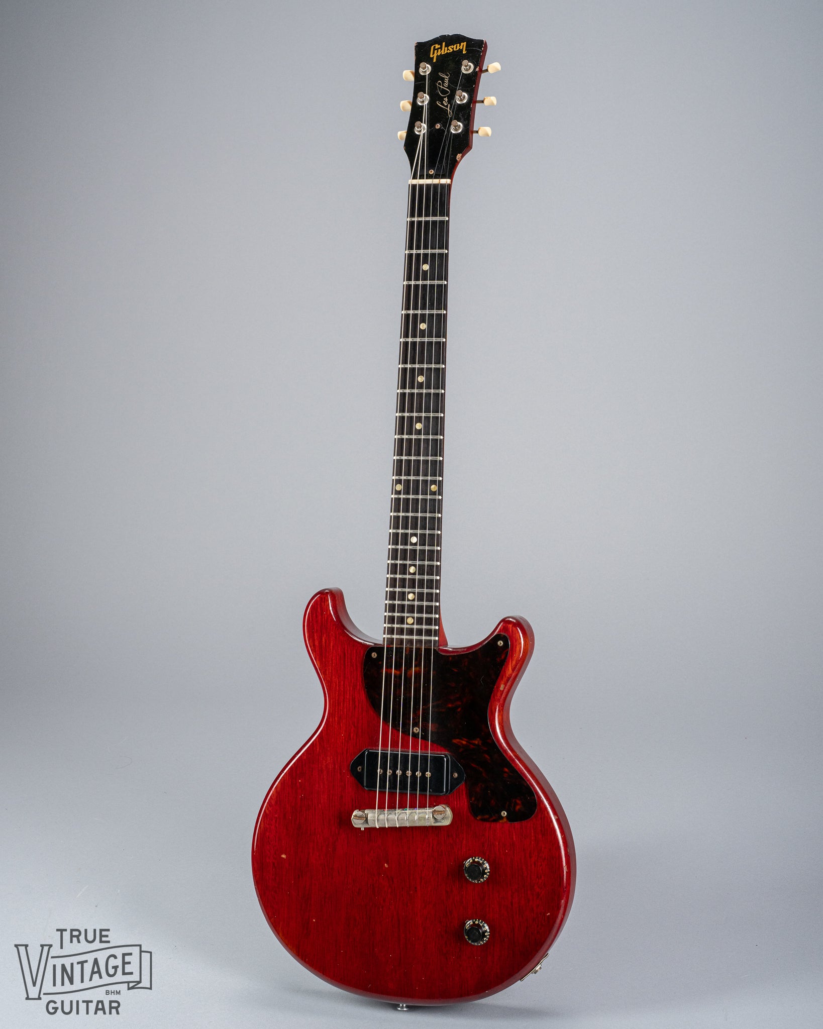 Front of 1959 Gibson Les Paul Junior cherry guitar dog ear p90 pickup tortoise pickguard volume and tone controls wrap around tail piece bridge fretboard original frets inlays neck headstock logo tuners