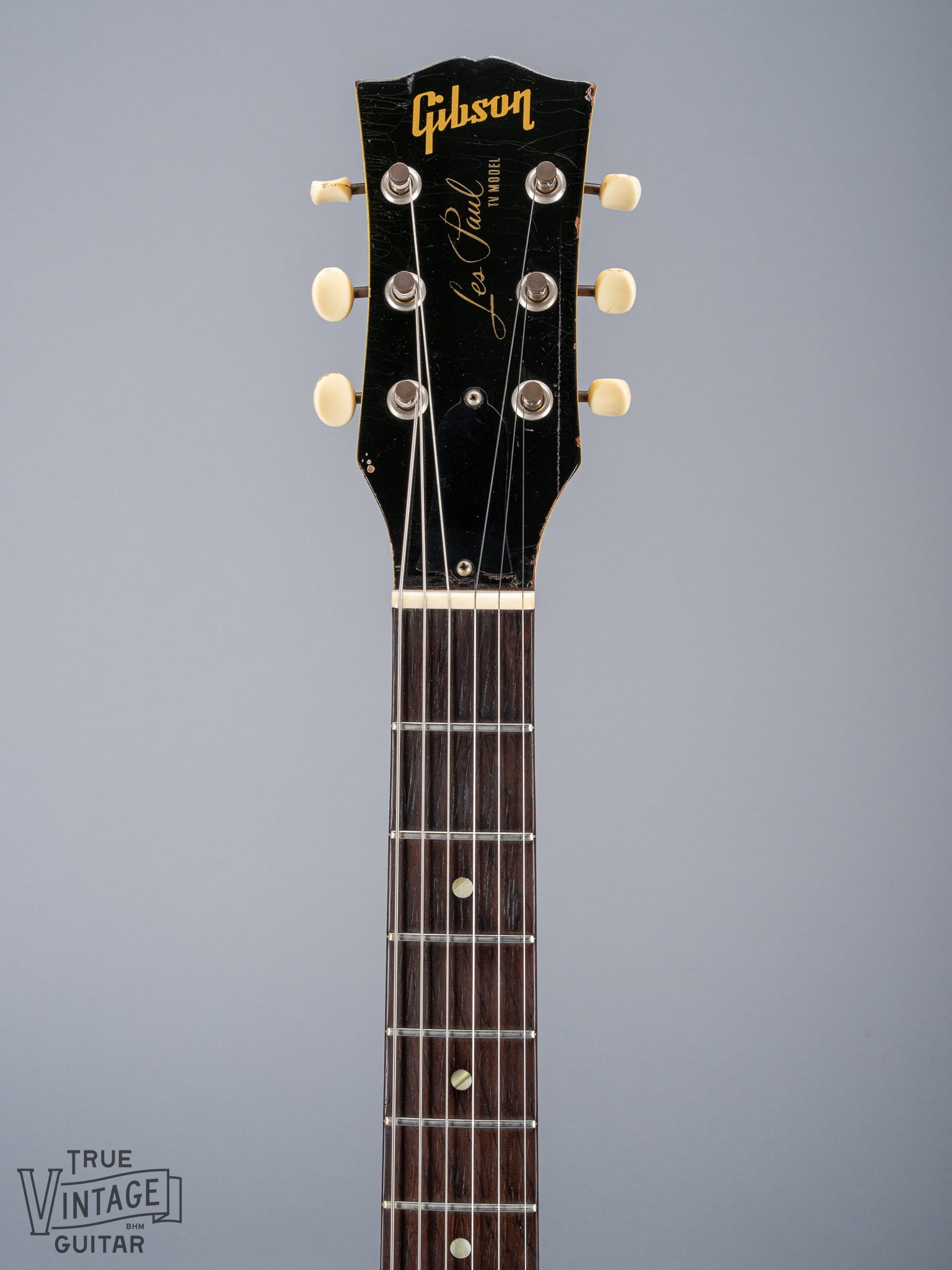 Front of 1959 Gibson Les Paul TV Model headstock, Logo, TV yellow, tuning machines, tuner buttons, neck, fretboard