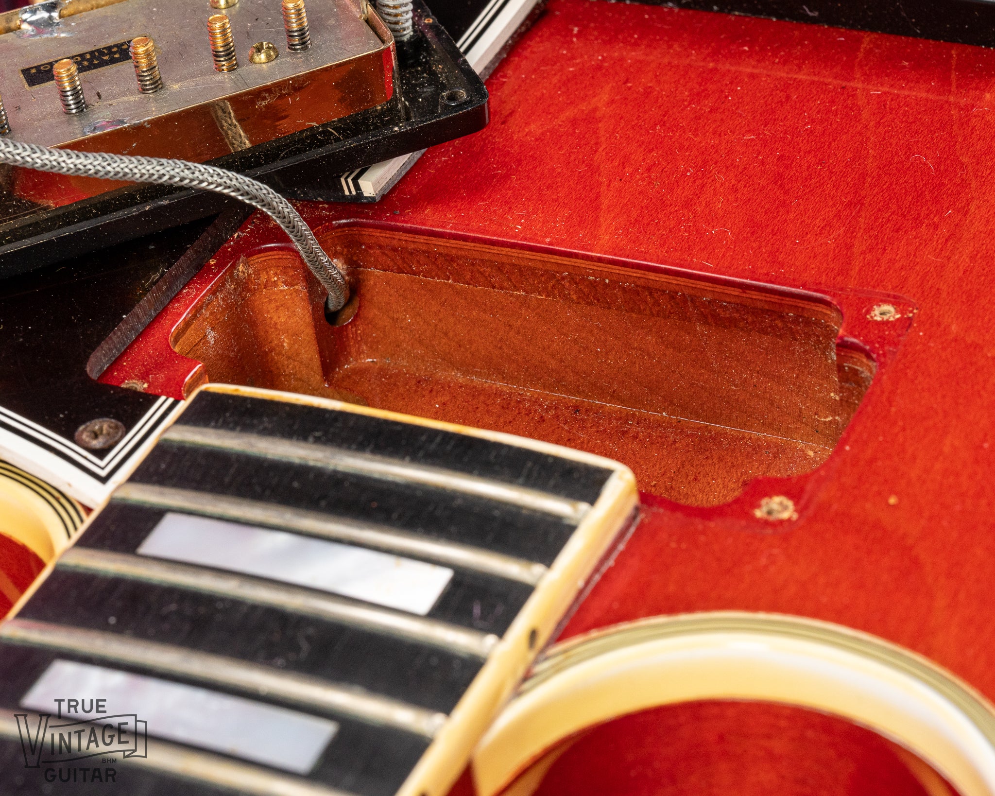 Thin top view from the neck pickup cavity showing solid Spruce layer