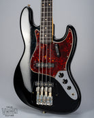 Front of 1962 Fender Jazz Bass custom color black custom color guitar tortoise shell pick guard no bridge and pickup cover finish checking