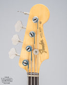 Front of 1962 Fender Jazz Bass custom color black custom color guitar HEadstock tuners Fender logo and print silk wrapped strings