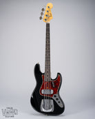 Front of 1962 Fender Jazz Bass custom color black custom color guitar tortoise shell pick guard fretboard headstock tuners 