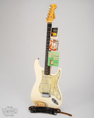 1962 Fender Stratocaster Olympic White guitar with hang tags, instruction manual, strap, and polish cloth.