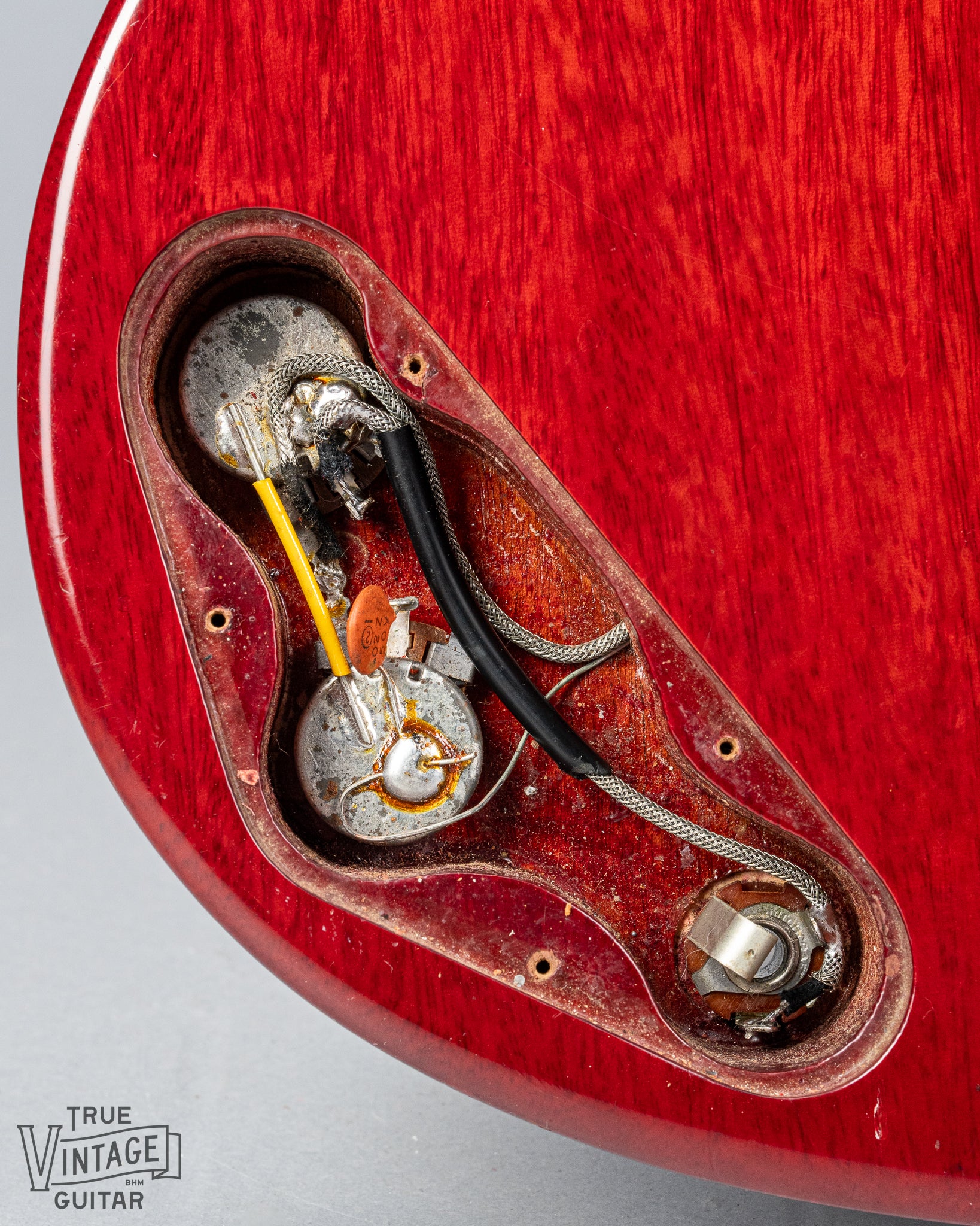 Front of Gibson Les Paul Junior Cherry red guitar control cavity electronics pots wiring output jack