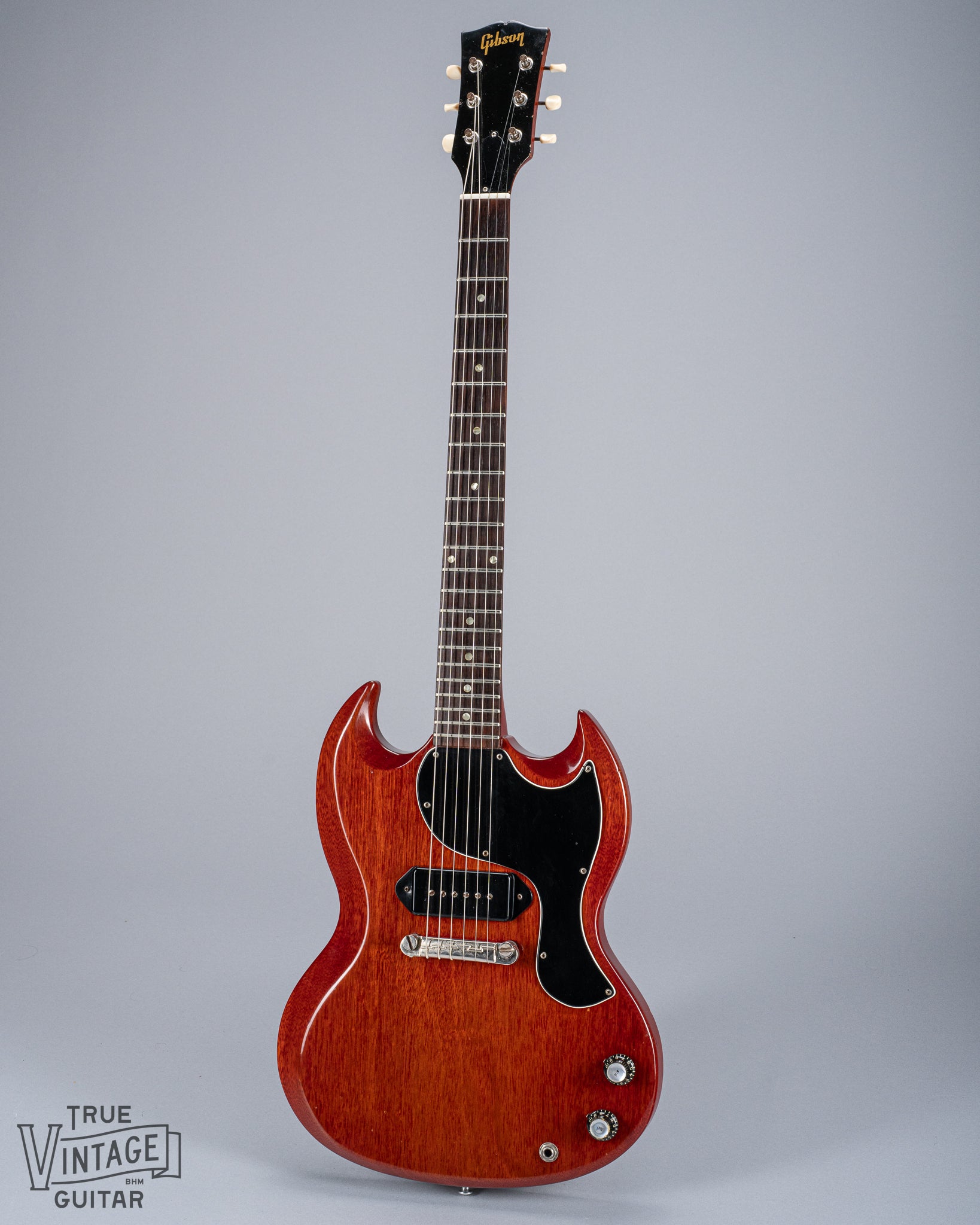 Front of 1964 Gibson SG Junior Cherry body pickguard dog ear P90 bridge wrap around tailpiece volume and tone controls fretboard original frets headstock tuners Gibson logo