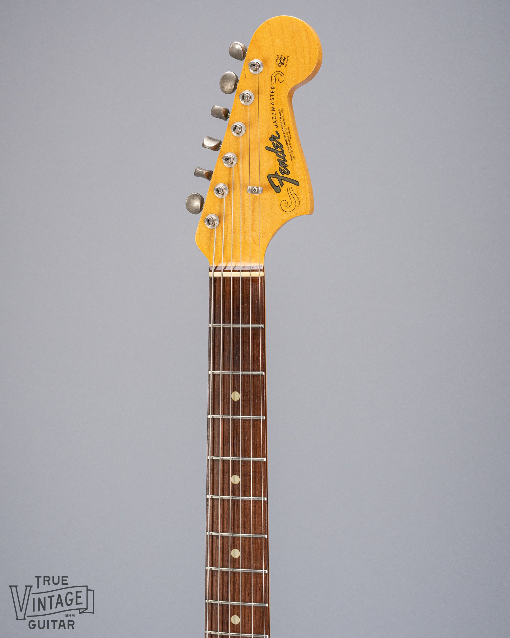 Front of 1965 Fender Jazzmaster sunburst guitar neck and headstock logo 