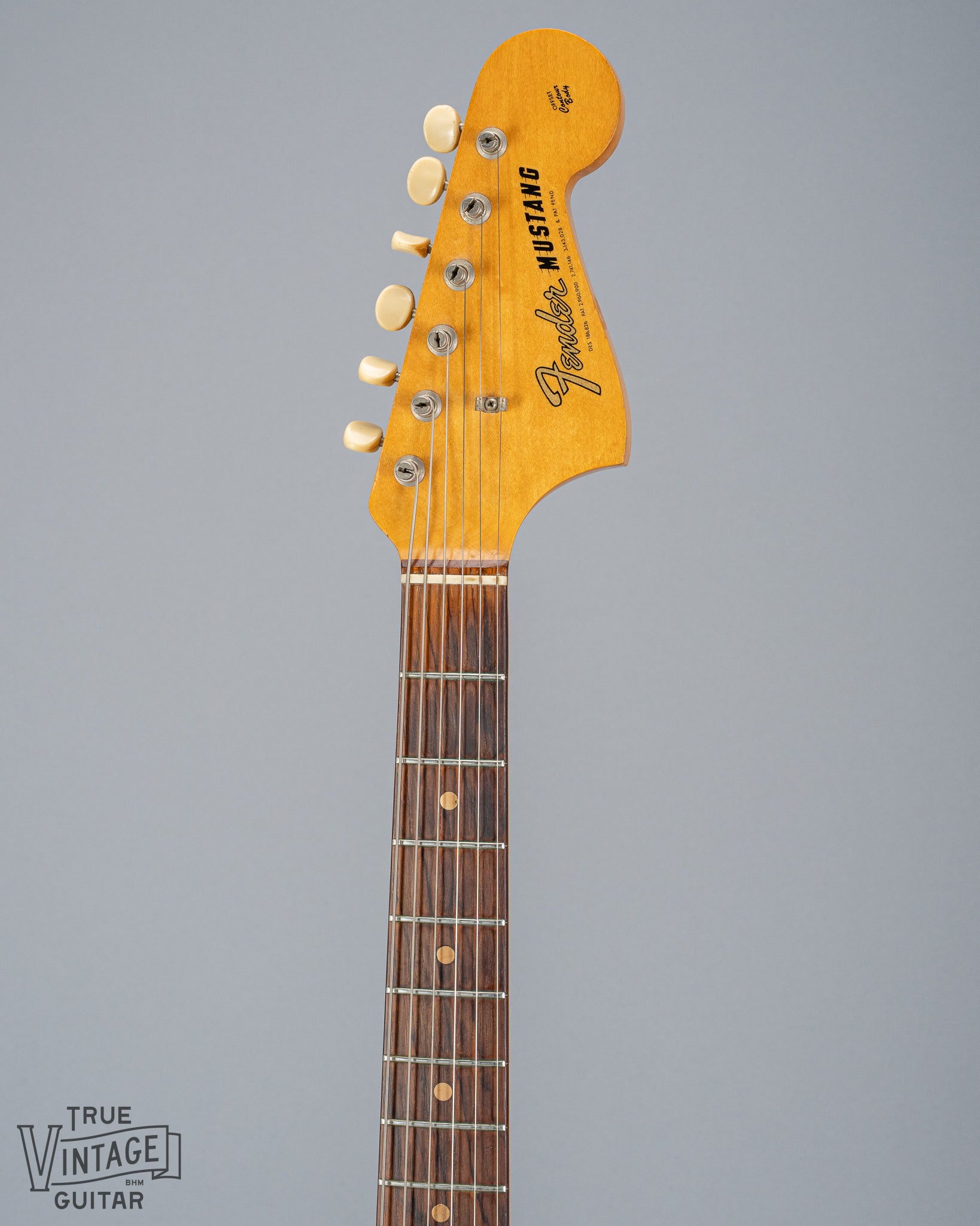 front of 1965 Fender Mustang Red guitar neck and headstock fretboard frets inlays tuning buttons 