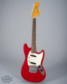 front of 1965 Fender Mustang Red guitar sparkle pick guard single coils original hardware neck fretboard headstock logo tuning buttons 