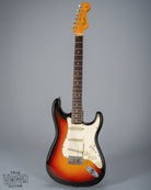 front of 1965 Fender Stratocaster Sunburst guitar body neck and headstock fretboard 3 ply pickguard single coil pickups volume and tone controls bridge tremolo arm