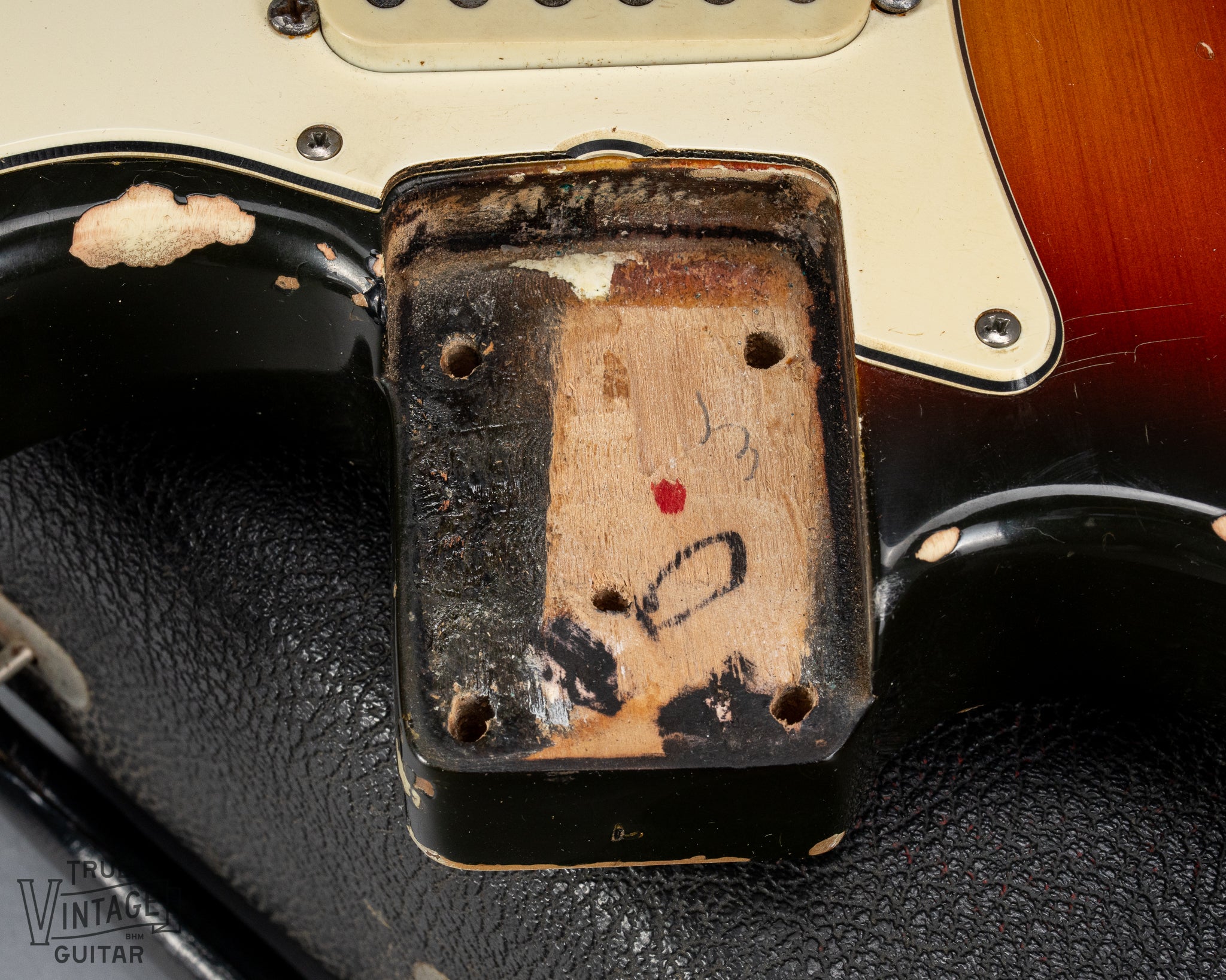 1970 Fender Stratocaster sunburst over white guitar neck pocket