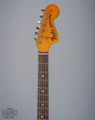 front of 1970 Fender Stratocaster sunburst over white headstock Fender logo tuners and original nut fretboard pearloid inlays 