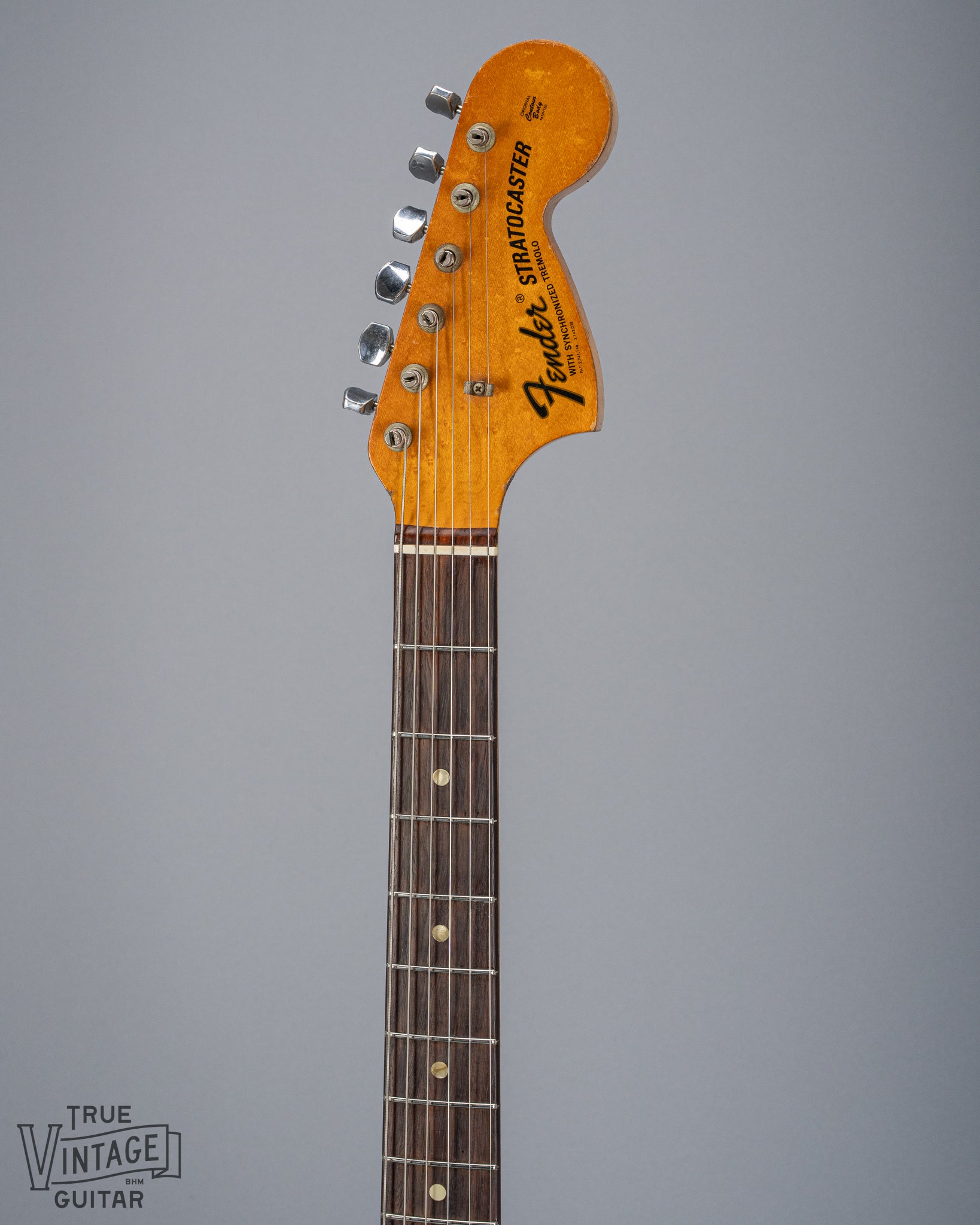 front of 1970 Fender Stratocaster sunburst over white headstock Fender logo tuners and original nut fretboard pearloid inlays 