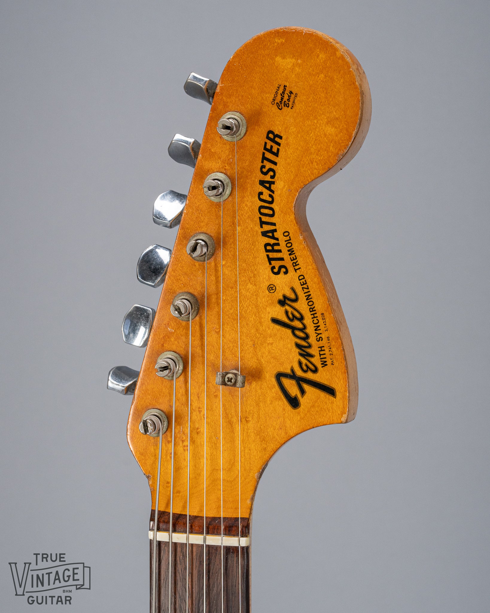 front of 1970 Fender Stratocaster sunburst over white headstock Fender logo tuners and original nut 