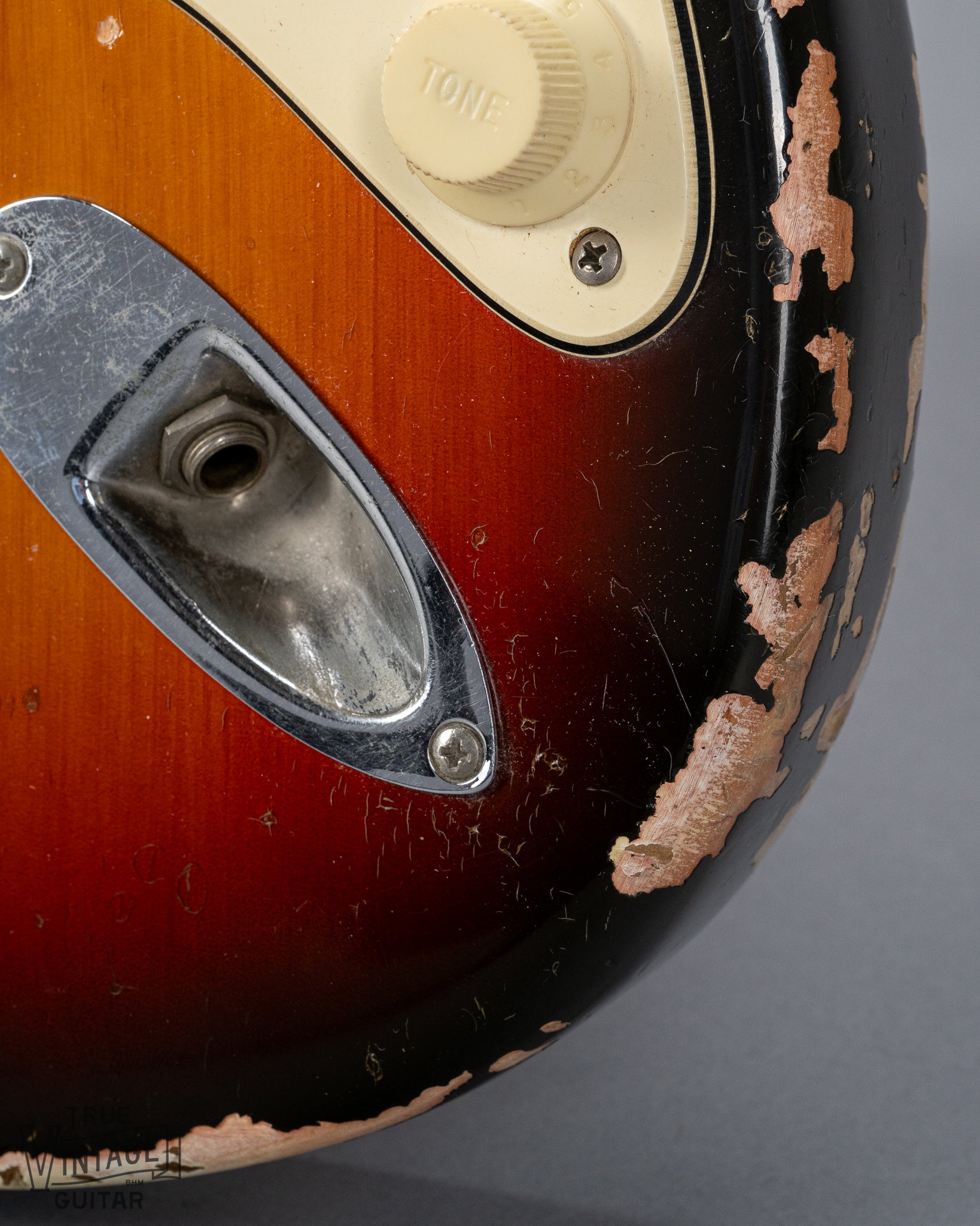 front of 1970 Fender Stratocaster sunburst over white finish distress 