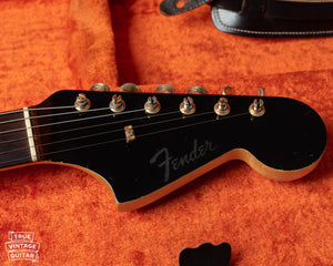 Black matching headstock with gold hardware and clipped Fender logo. No model name.